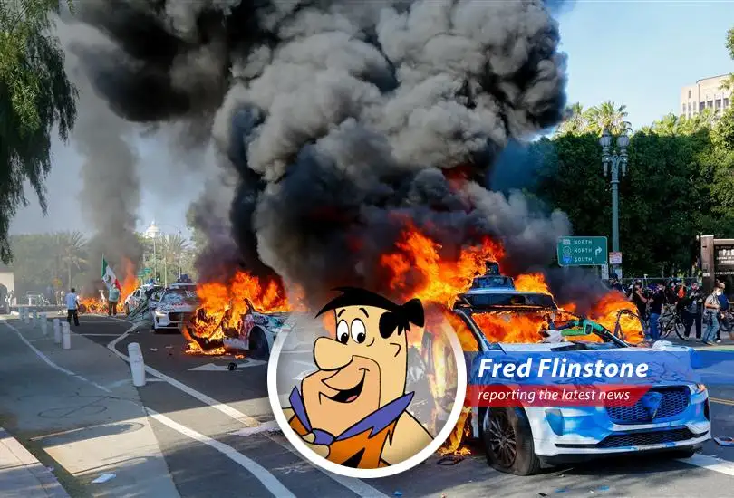 Fred Flinstone reports on the fiery fate of robotaxis in downtown Los Angeles amidst protests, leaving him wondering if technology is ready for Bedrock... I mean, LA!