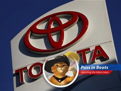 Puss in Boots reports on Toyota's predicted profit dip, blaming tariffs, a strong yen, and maybe a grumpy Presidente. image